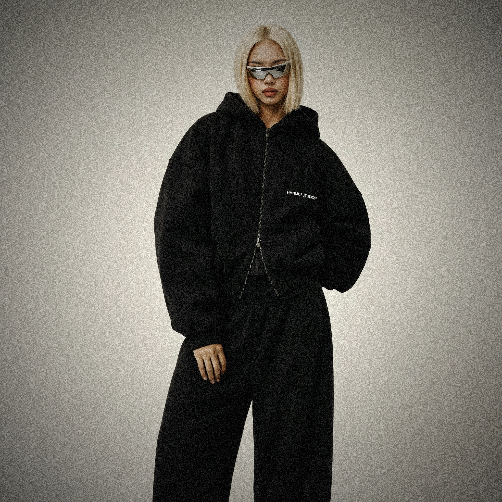 HVNMDE V2 heavy zip — woman wearing the black zip hoodie set